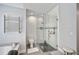 The bathroom has a glass shower, modern fixtures, and updated flooring at 5565 Sweetwater Oak Dr, Sarasota, FL 34232