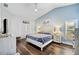 This bedroom boasts a vaulted ceiling, a ceiling fan, and an accent wall at 5565 Sweetwater Oak Dr, Sarasota, FL 34232
