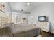 Large bedroom with ensuite bathroom featuring a neutral palette and wood flooring at 5565 Sweetwater Oak Dr, Sarasota, FL 34232