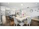 Open concept dining room and kitchen area featuring a white dining table and kitchen island with bar seating at 5565 Sweetwater Oak Dr, Sarasota, FL 34232