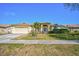 Attractive single-story home featuring a manicured lawn, stone walkway, and an attached two-car garage at 5565 Sweetwater Oak Dr, Sarasota, FL 34232