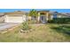 Charming single-story home featuring a well-manicured lawn, lovely landscaping, and an attached two-car garage at 5565 Sweetwater Oak Dr, Sarasota, FL 34232