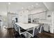 Spacious kitchen featuring a large island with seating, stainless steel appliances, and modern gray cabinetry at 5565 Sweetwater Oak Dr, Sarasota, FL 34232