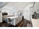 Contemporary kitchen with large island, bar seating, and open layout to the living room, perfect for entertaining at 5565 Sweetwater Oak Dr, Sarasota, FL 34232