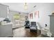 Cozy living area with natural light, hardwood floors, and comfortable reclining chairs near a window at 5565 Sweetwater Oak Dr, Sarasota, FL 34232