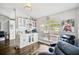 Cozy living area features a window, natural light, hardwood floors, a dry bar, and comfortable reclining chairs at 5565 Sweetwater Oak Dr, Sarasota, FL 34232