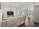 Open concept living room with a white sofa, vaulted ceilings, and seamless flow into the kitchen at 5565 Sweetwater Oak Dr, Sarasota, FL 34232