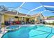 Inviting screened-in pool and spa with a spacious deck, perfect for outdoor entertaining at 5565 Sweetwater Oak Dr, Sarasota, FL 34232