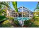 The enclosed pool area provides a private outdoor space surrounded by lush landscaping at 5565 Sweetwater Oak Dr, Sarasota, FL 34232