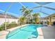 A beautifully landscaped pool area features lush greenery and a sparkling pool for relaxation at 5565 Sweetwater Oak Dr, Sarasota, FL 34232