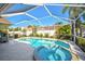 Private screened-in pool and spa with a sun-drenched deck for relaxation at 5565 Sweetwater Oak Dr, Sarasota, FL 34232