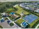 Aerial view of the community amenities including playground, basketball court, and shaded seating areas at 6239 Baywood Ct, Bradenton, FL 34211