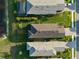 Bird's eye view of home rooftops and backyard landscaping in a neatly planned community near lake at 6239 Baywood Ct, Bradenton, FL 34211