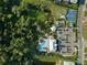 Aerial view showcases community amenities including pool, clubhouse, playground, parking and basketball court at 6239 Baywood Ct, Bradenton, FL 34211
