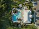 Aerial view showcasing community pool, clubhouse, fire pit, lounge areas, parking and lush landscaping at 6239 Baywood Ct, Bradenton, FL 34211