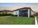Home featuring a well-manicured lawn and a screened patio for enjoying the outdoors at 6239 Baywood Ct, Bradenton, FL 34211
