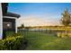 The backyard offers a beautiful view of a pond with tropical landscaping around the yard at 6239 Baywood Ct, Bradenton, FL 34211