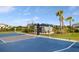 Community basketball court near shaded seating area and lush landscaping provides a great recreational amenity at 6239 Baywood Ct, Bradenton, FL 34211