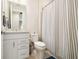 Neutral bathroom design with vanity, toilet, and shower with curtain at 6239 Baywood Ct, Bradenton, FL 34211