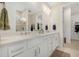 Well-lit bathroom featuring a double sink vanity and neutral finishes at 6239 Baywood Ct, Bradenton, FL 34211