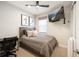 Cozy bedroom with modern decor, ceiling fan, and a mounted TV at 6239 Baywood Ct, Bradenton, FL 34211