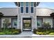 Inviting clubhouse entrance with a glimpse of the pool area through a gated entry, showcasing lush landscaping at 6239 Baywood Ct, Bradenton, FL 34211