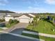 Beautiful single Gathering home showcasing a well manicured lawn, neutral color palette, and a two car garage at 6239 Baywood Ct, Bradenton, FL 34211