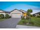 Charming single-story home with a two-car garage, manicured lawn, and a welcoming entrance at 6239 Baywood Ct, Bradenton, FL 34211