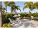 Outdoor grilling area featuring stainless steel grills, seating, and lush landscaping for convenient outdoor cooking at 6239 Baywood Ct, Bradenton, FL 34211