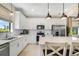 Well-equipped kitchen featuring white cabinetry, quartz countertops, stainless steel appliances, and a functional layout at 6239 Baywood Ct, Bradenton, FL 34211
