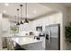 Bright kitchen with white cabinets, stainless steel appliances and a large island with bar seating at 6239 Baywood Ct, Bradenton, FL 34211