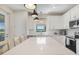 Bright kitchen with white cabinets, stainless steel appliances, quartz countertops, and a view of the lush surroundings at 6239 Baywood Ct, Bradenton, FL 34211
