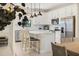 Bright kitchen with white cabinets, stainless steel appliances and a large island with bar seating at 6239 Baywood Ct, Bradenton, FL 34211