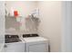 This laundry room features a Whirlpool washer and dryer with wire shelving for storing supplies at 6239 Baywood Ct, Bradenton, FL 34211