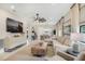 Bright living room with a large sectional sofa, modern decor, and an open layout leading to the kitchen and dining area at 6239 Baywood Ct, Bradenton, FL 34211