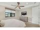 Calm main bedroom with ceiling fan, TV, and large windows overlooking the community at 6239 Baywood Ct, Bradenton, FL 34211