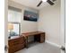 This home office features a wood desk with storage and an abundance of natural light at 6239 Baywood Ct, Bradenton, FL 34211