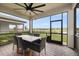 Screened patio features a dining table and views of the backyard and neighborhood pond at 6239 Baywood Ct, Bradenton, FL 34211