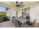Covered patio features a dining table and ceiling fan for year-round outdoor enjoyment at 6239 Baywood Ct, Bradenton, FL 34211