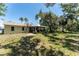 Expansive backyard featuring lush greenery, shade trees, and a peaceful setting at 712 68Th W Ave, Bradenton, FL 34207