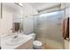 Bathroom with a walk-in shower featuring glass doors, and neutral colored walls at 712 68Th W Ave, Bradenton, FL 34207