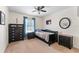 Neutral colored bedroom with a ceiling fan, window with blinds, a dark wooden bed, and dresser at 712 68Th W Ave, Bradenton, FL 34207