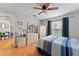 Cozy bedroom with hardwood floors, neutral walls, ceiling fan, and a well-lit window at 712 68Th W Ave, Bradenton, FL 34207