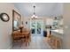 Cozy dining area with tile flooring, dining table, and access to the outdoors at 712 68Th W Ave, Bradenton, FL 34207