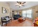 Comfortable living room with wood floors, ceiling fan, and natural light from the windows at 712 68Th W Ave, Bradenton, FL 34207