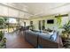 Enclosed porch with outdoor furniture and an exterior view from large screened windows at 712 68Th W Ave, Bradenton, FL 34207