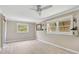 Bright bedroom features wood floors, ceiling fan and lots of natural light at 7211 Cloister Dr # 101, Sarasota, FL 34231