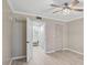 Bedroom featuring a view to a bathroom with plank floors, light-colored walls, and a ceiling fan at 7211 Cloister Dr # 101, Sarasota, FL 34231