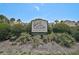 Inviting sign for Gulf Gate Gardens Condominium surrounded by lush landscaping at 7211 Cloister Dr # 101, Sarasota, FL 34231