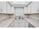Clean and functional kitchen with modern countertops and a stainless steel sink at 7211 Cloister Dr # 101, Sarasota, FL 34231